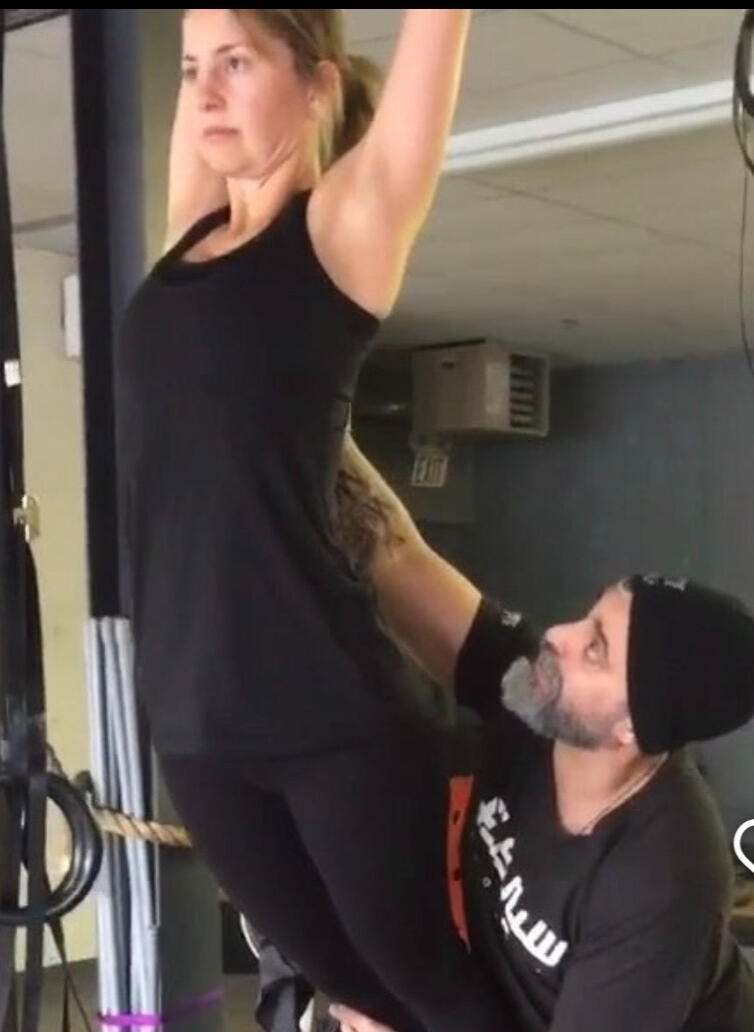 Oakville Personal Training Personal trainer assisting a client with a movement exercise in Oakville